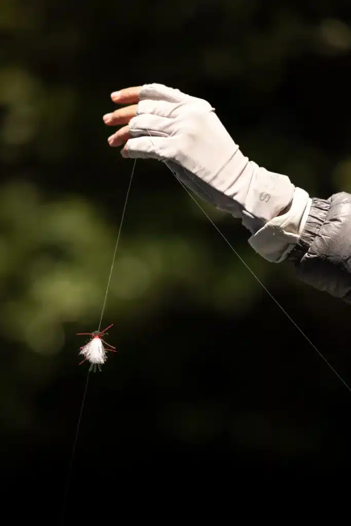 womans hand holding dry fly fishing patagonia