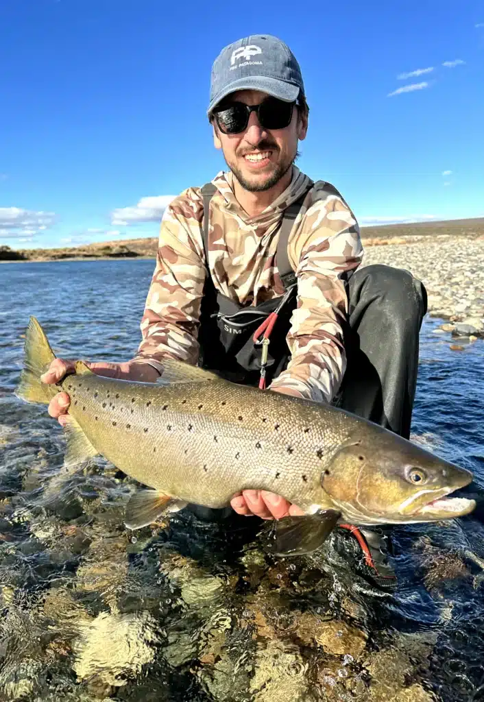 fisherman with large trout limay river patagonia